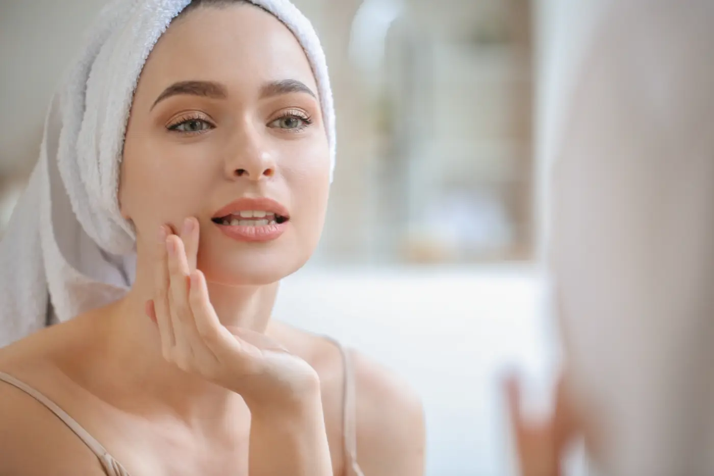 Woman with a towel wrap caring for her skin