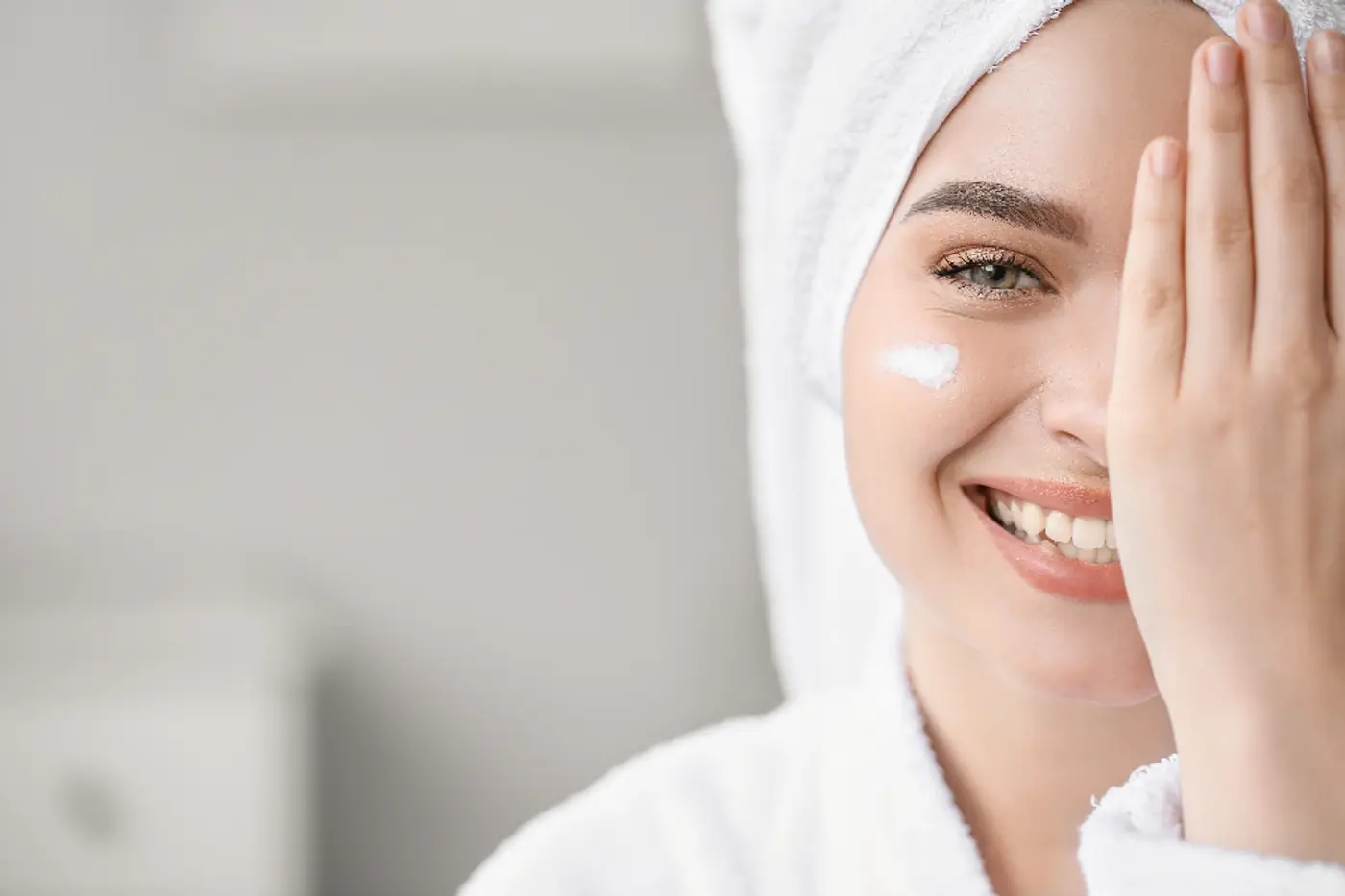 Woman with moisturiser on her cheek