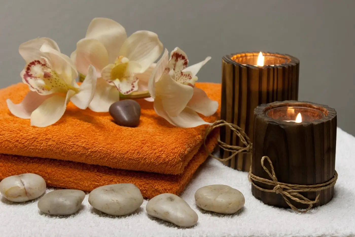 Spa towels, orchids and candles ready for a treatment