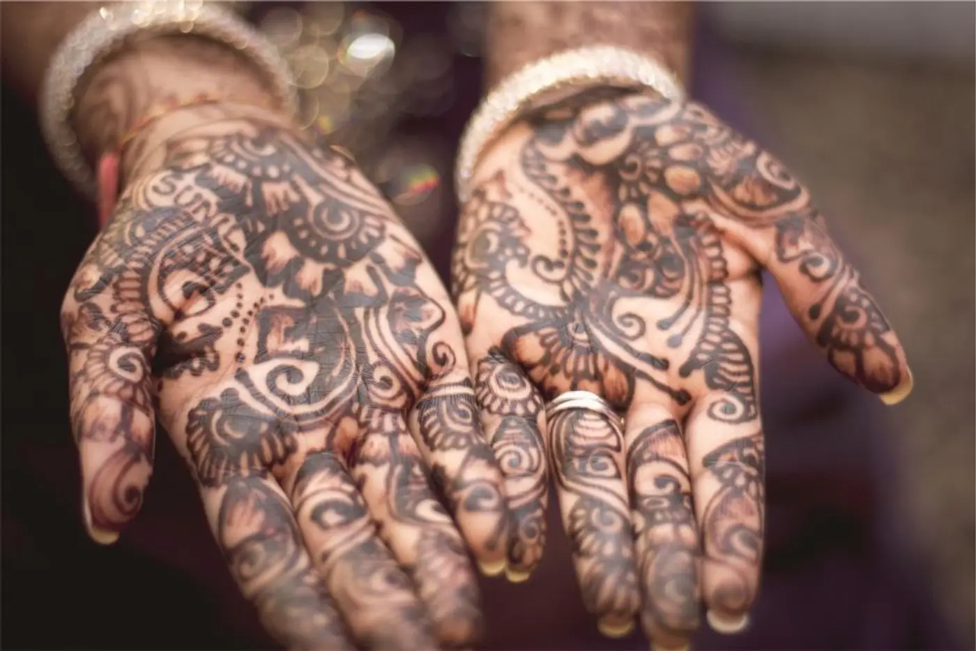 Hands decorated with intricate henna