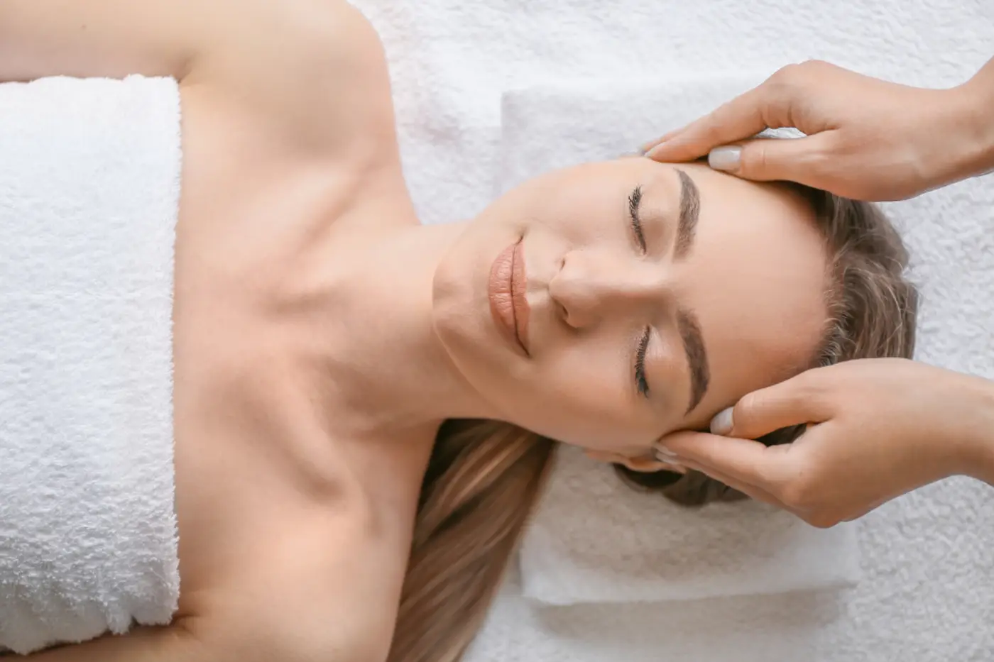 Woman relaxing during a facial massage
